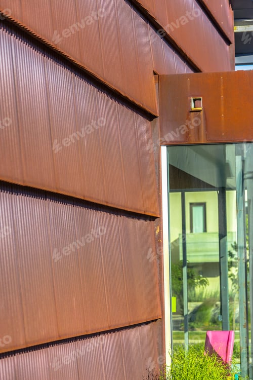 Preview: Metal Panels Of Building In Sun With Window