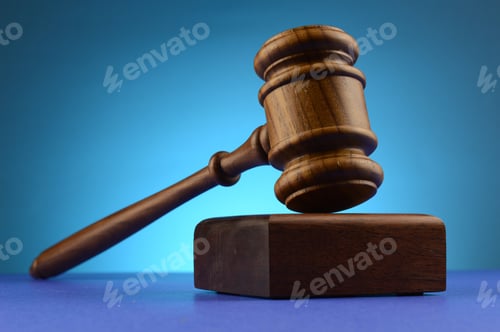 Preview: A Legal Gavel And Block Over A Blue Background.