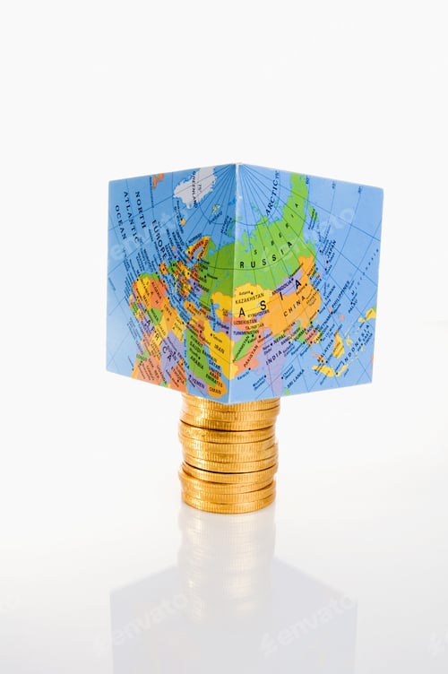 Vista previa: A Cube-Shaped Globe Sitting On Top Of A Pile Of Gold Coins.