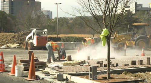 Preview: Workers Using A Grinder On A New Concrete Installation At A Construction Site