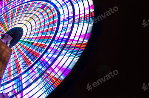 Preview: Looking Up At A Colorful Illuminated Ferris Wheel Spinning Against The Black Night Sky