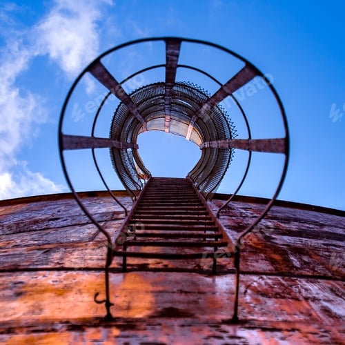 Preview: Ladder Of An Old Gas Tank Under Clear Blue Sky