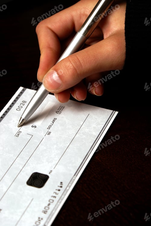 Preview: A Macro Shot Of A Person Writing A Check.