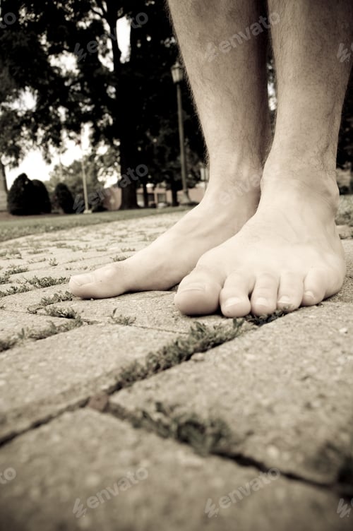 Preview: A Pair Of Feet On A Stone Walkway.