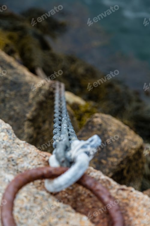 Preview: An Old Rusted Iron Ring And Chain Securing A Ramp To A Pier
