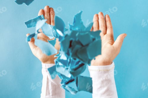Preview: Person'S Hands Throwing Crumpled Paper Pieces Into The Air