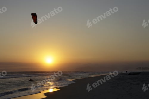 Kitesurfing at Sunset on a Beach