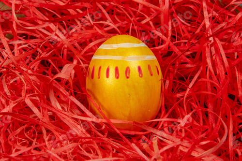 Preview: Painted Eggs Symbolizing Easter Over Straw Red Background