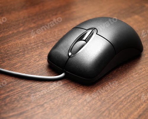 Preview: A Plastic Computer Wheel Mouse On A Wooden Surface.