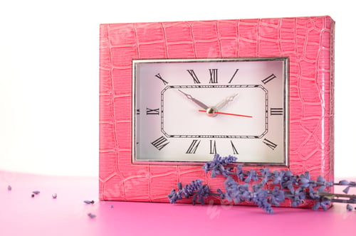 Preview: A Closeup View Of A Pink Alligator Clock With Some Accent Lavender Over A Pink And White Background.