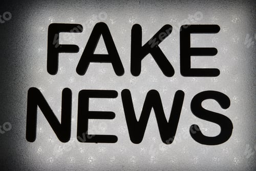 Preview: Word "Fake News" Written In Wood Letters And Lit By Background In Backlight