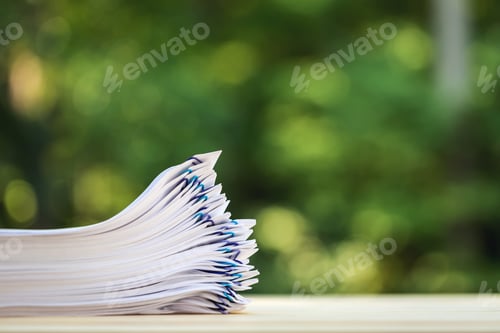 Preview: A Stack Of Documents On A Shiny Green Forest Background