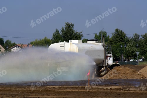 Preview: Water Truck Sprays Construction Job Site For Compaction And Dust Control
