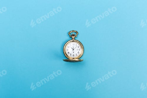 Preview: Small Golden Watch On A Light Blue Background