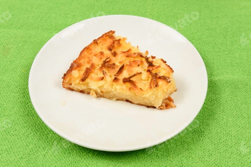 Whole Cassava Cake On Green Fabric Background.