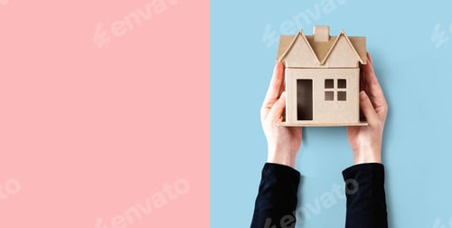 Preview: Woman Holding A Cardboard House Overhead View