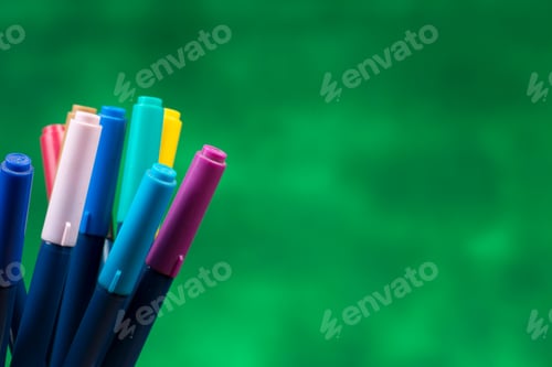 Preview: Creativity Of Colorful Colored Pen In Pencil Case With Copy Space On Blurred Green Background.