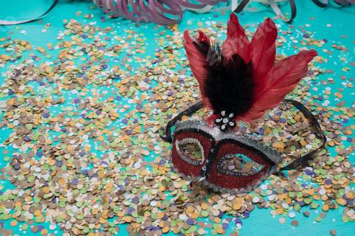 Preview: Confetti Spread On Blue Background With A Female Carnival Mask.