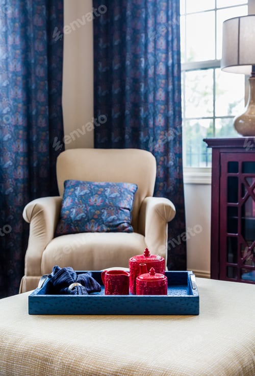 Preview: Red Ceramic Tea Set On Wooden Blue Tray On A White Ottoman In A Den