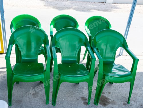 Preview: Six Green Plastic Chairs In The Shade