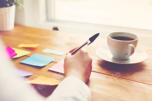 Preview: Person Organizing Things With Pastel Sticky Notes At A Desk