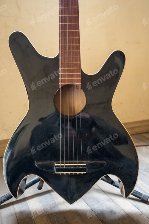 Unusual Acoustic Guitar on a Stand Inside