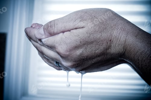Preview: Two Hands Clasped Holding Suds That Are Dripping.
