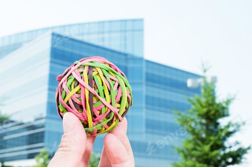 Preview: A Hand Holding A Ball Made Of Rubber Bands.