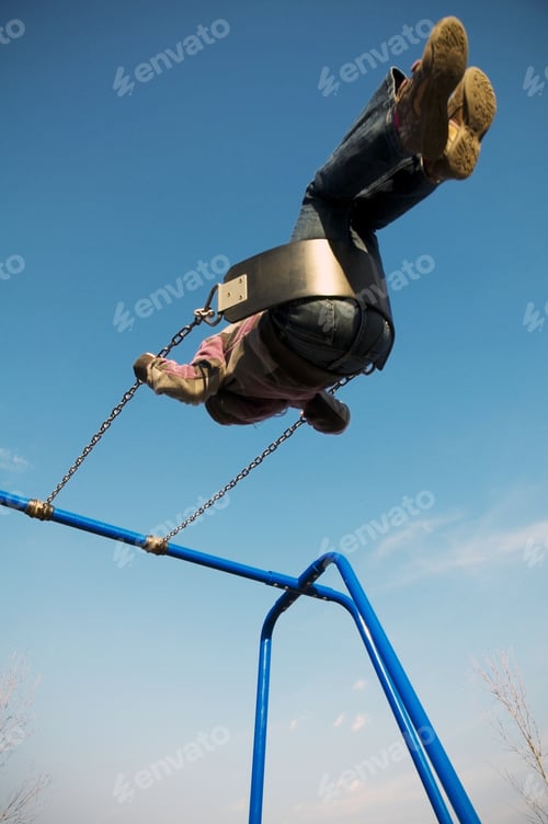 Preview: Looking Up At A Child In Motion As They Swing Towards The Sky.