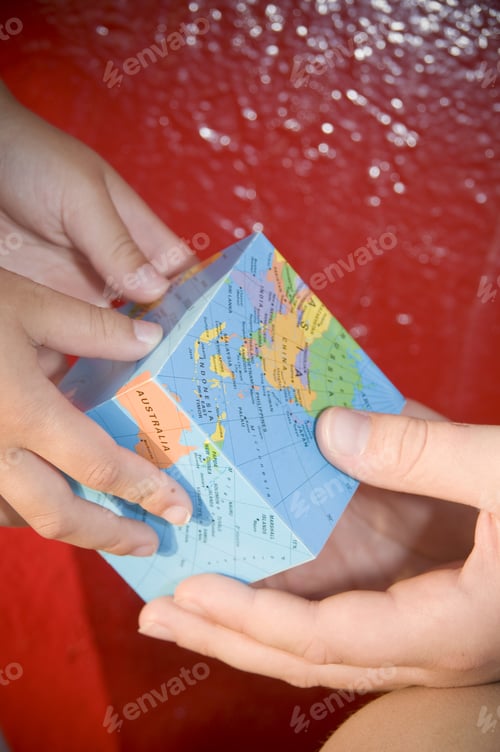 Preview: An Adult And Child Holding A Square Globe.