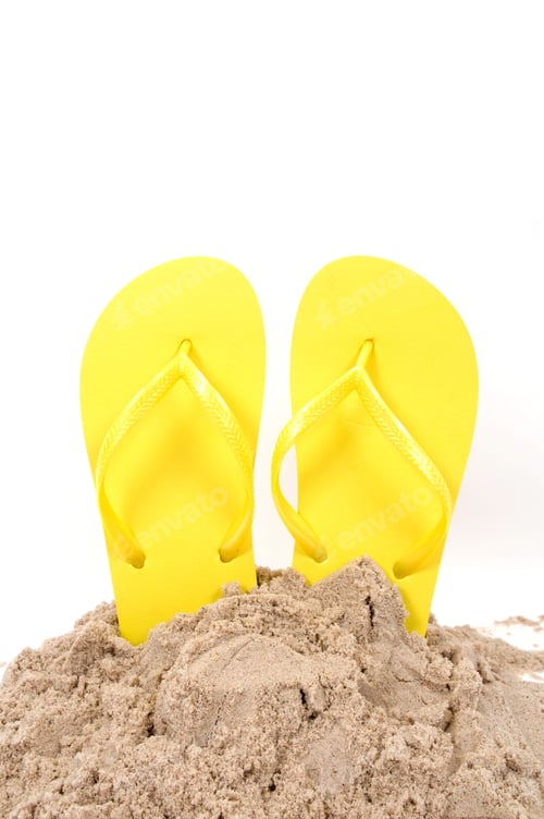 Preview: Bright Yellow Flip Flops in Sand on White