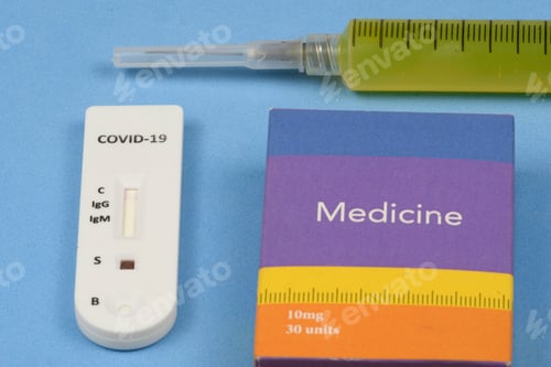 Preview: Rapid Coronavirus Test With Syringe Yellow Liquid And A Medicine Box