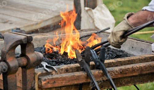 Preview: Blacksmith Heating Up Tools In Fire