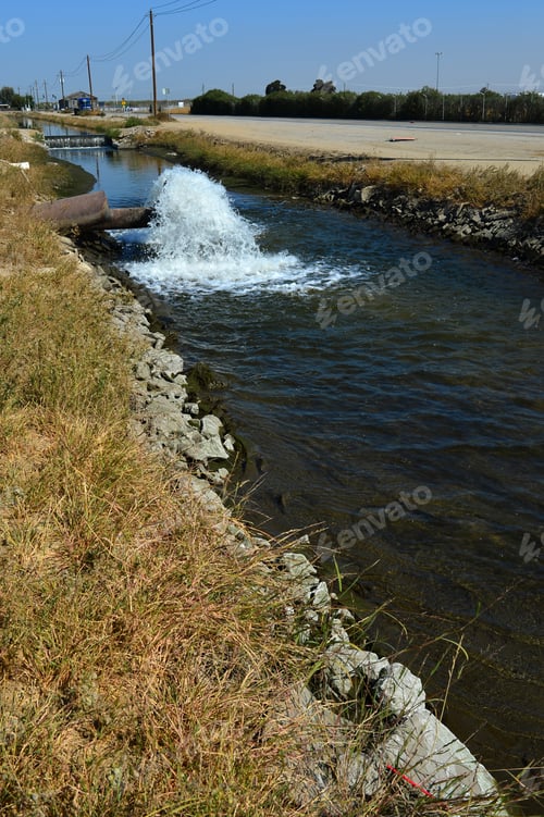 Preview: Water Gushes From A Pipe Into A Farm Irrigation Canal In Central California. The Drought In Prior