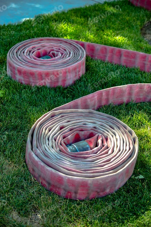 Preview: Two Rolled Fire Hoses On Grass