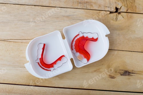 Preview: Red Dental Retainer In Box On Wooden Background
