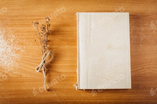 Preview: Book On Wooden Table With Dry Grass