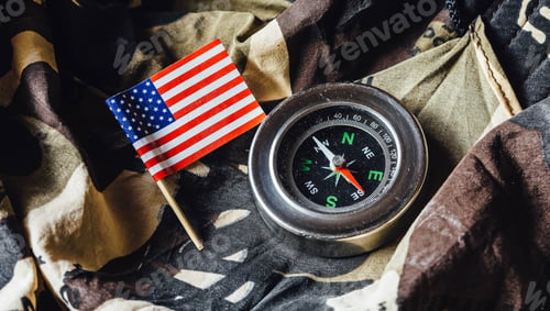 Preview: Old Magnetic Compass And Us Flag On A Camouflage Fabric Of War.