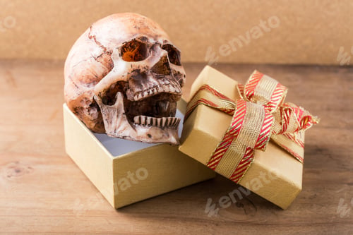 Preview: Model Skull With Gift Box On Wooden Background
