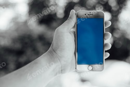 Preview: Man Hand Holding Smartphone Against Spring Green Background, Smartphone With Color Background