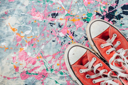 Preview: Red Sneakers On Jean With Splash Color Background