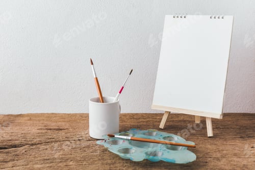 Preview: Painting Supplies with Easel and Brushes on Wood