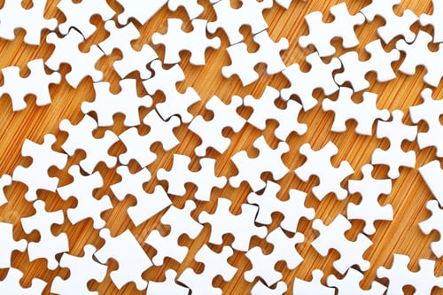 Preview: White Puzzle On Wooden Background