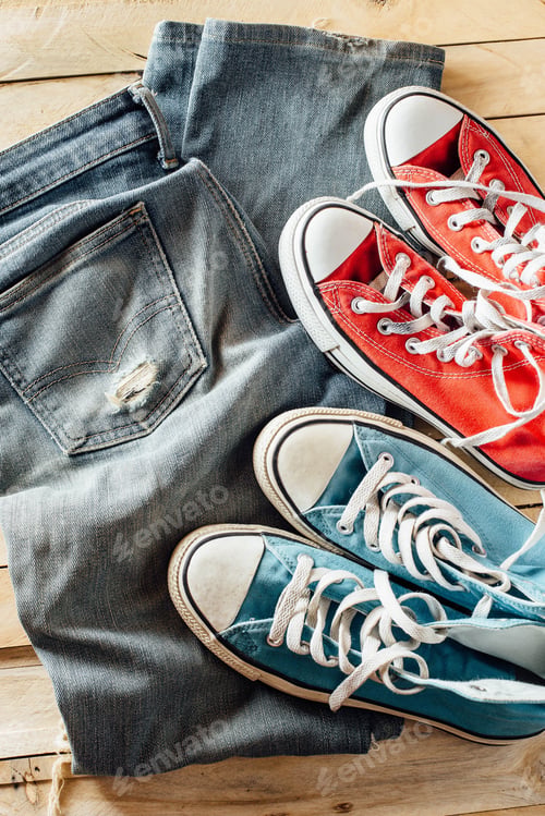 Preview: Old Jeans On Wooden Floor With A Pair Of Sneakers,Red Sneakers And Blue Sneaker