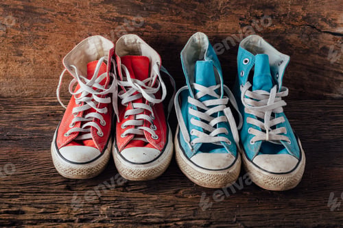 Preview: Blue Sneakers And Red Sneaker On Wooden Floor