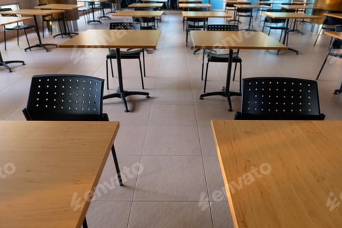 Preview: Tables And Chairs That Is Arranged Spaced Or Social Distancing In The Dining Room Without People.