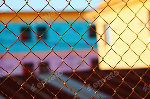 Preview: Colorful House Wall Behind A Chain Link Fence