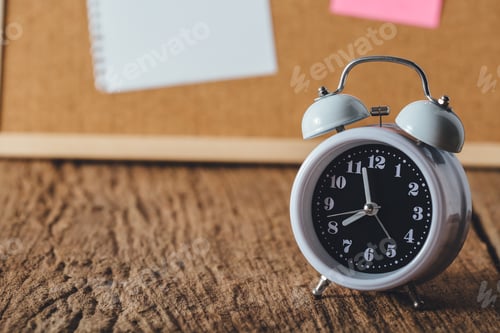 Preview: Alarm Clock With Paper Note On Cork Board Background, On Wooden Table