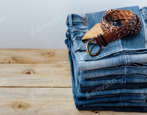 Preview: Jeans And Leather Belt On Wooden Table