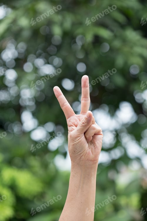 Preview: Hand With Two Fingers Up,Victory Symbol On Green Background
